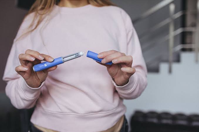 Woman holding Ozempic Pen